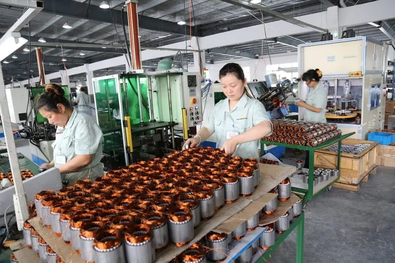 Stator Winding Process – Skilled workers winding motor stators